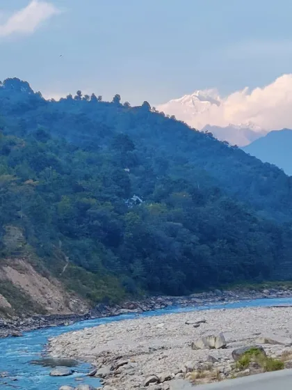 The view from the road on our way to Chopta, with the Alaknanda river below and the first peek of snow-covered Himalayan peaks in the distance.
