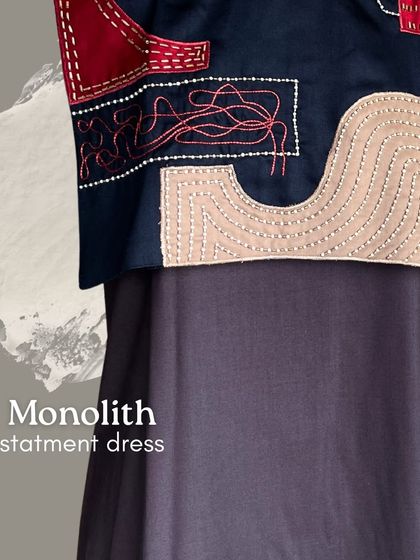 Bold as stone, fluid as art. This is a close-up of the Monolith Statement Dress, a masterpiece from the collection where textured patchwork and hand embroidery meet timeless elegance.