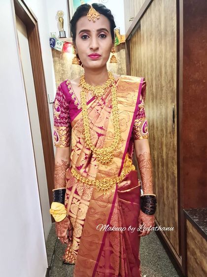 This bride is ready for her Muhurtham. This is a real phone click showing the makeup in natural lighting, featuring a rich silk saree and layered gold necklaces.