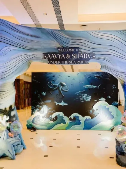 We love creating magical entrances that transport guests to another world. This 'Under the Sea' party entrance features a stunning wave arch and deep-sea backdrop, setting the stage for an aquatic adventure.