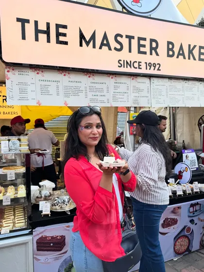 We love capturing these moments of joy. Another happy customer enjoying a slice of our pastry at our bustling festival stall.