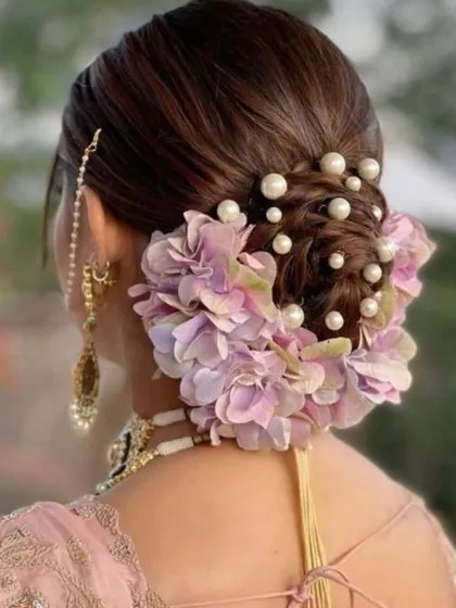 You will learn to create stunning bridal hairstyles like this elegant floral bun. My advanced hair course covers everything from classic updos to trendy, modern styles.