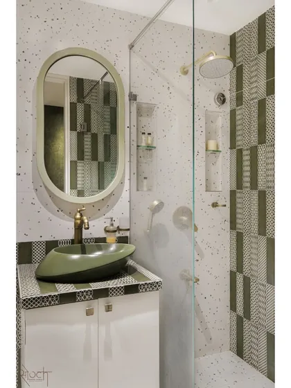 The attached bathroom for the young couple's room continues the olive green theme with patterned tiles and a unique boat-shaped basin, creating a cohesive and stylish suite.
