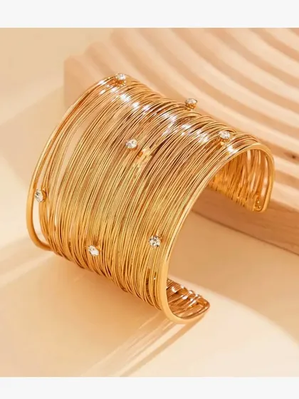 A clean, angled shot of the statement mesh cuff bangle, showing the delicate crystals embedded in the wire.