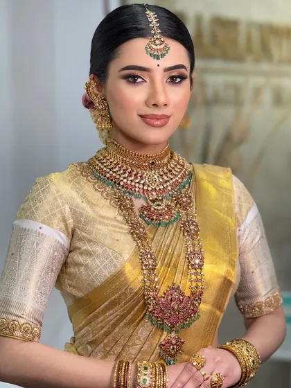 A classic portrait of the bride, looking straight at the camera. The makeup is clean and precise, highlighting her natural beauty.