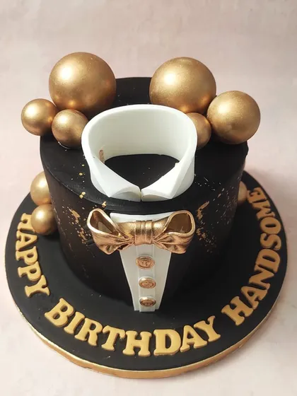 This elegant tuxedo cake is a perfect choice for Father's Day, celebrating dad in style.