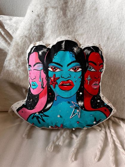 A hand-painted, hand-sewn, and embroidered 'mood pillow.' This soft sculpture plays with the idea of conveying discomfort through an object of comfort.