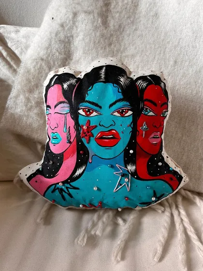 A hand-painted, hand-sewn, and embroidered 'mood pillow.' This soft sculpture plays with the idea of conveying discomfort through an object of comfort.