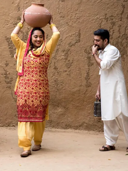 A creative, themed couple shoot with a rustic, traditional Punjabi village setting. I enjoy bringing unique concepts like this to life for pre-wedding or anniversary photos.