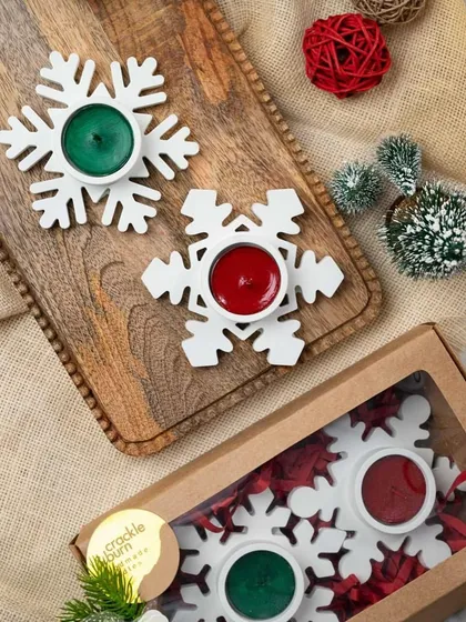 A beautiful, high-quality photo of the concrete snowflake tea light holders. They come in a set of two, packaged in a window box.