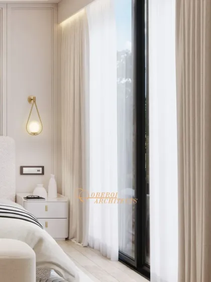 A detail shot showing the delicate wall sconce and the soft, sheer curtains that allow diffused natural light to fill the room.