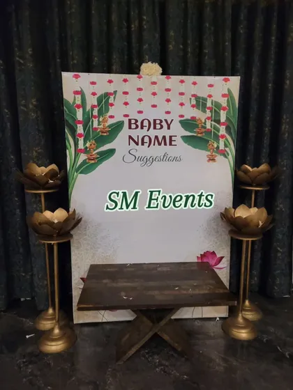 For this baby shower, I created a "Baby Name Suggestions" corner. The setup includes a custom-designed backdrop and lotus-shaped stands, inviting guests to share their creative name ideas for the new arrival.