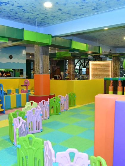 A wide shot of the toddler and soft play area at our Banashankari center. The open layout allows for easy supervision, and the colorful padded floors ensure a safe play surface.