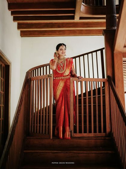 A beautiful portrait of the bride descending the wooden staircase, looking regal and graceful.