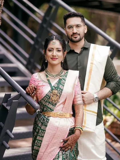 A beautiful couple, Ankita and Karan. For Ankita, I designed a light pink blouse with delicate embroidery to pair with her stunning dark green and pink Kanchivaram saree for their special day.