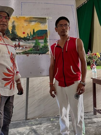 Posing with a completed landscape painting after a workshop at Gogamukh College Auditorium in Dhemaji.