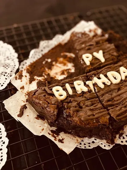 A perfectly imperfect shot of our "Happy Birthday" brownie cake after the first few delicious slices have been enjoyed.