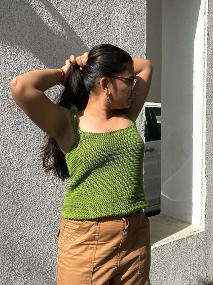 This handmade ruffle strap tank top is a great everyday piece. It's shown here in a bright green, but we can make it in any color you choose.