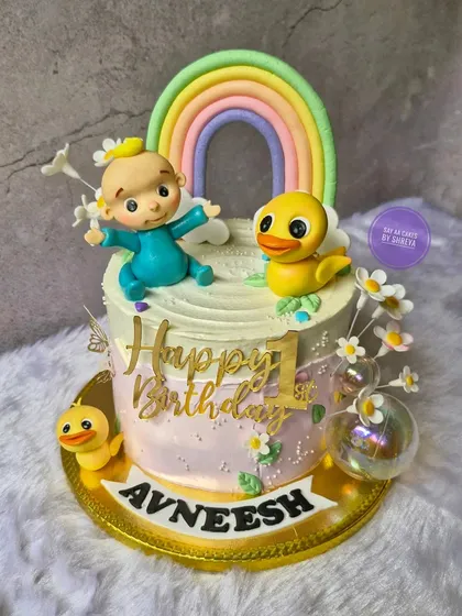Inspired by the cheerful world of CoComelon, this cake is perfect for a first birthday. It features a cute baby and ducky friend under a pastel rainbow, bringing a touch of nursery rhyme magic to the celebration.