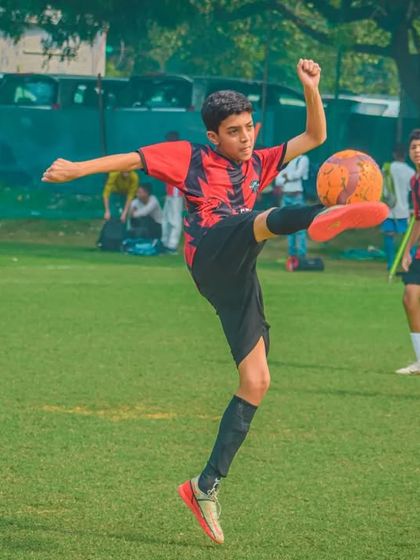 A player shows great technique as he controls a high ball.