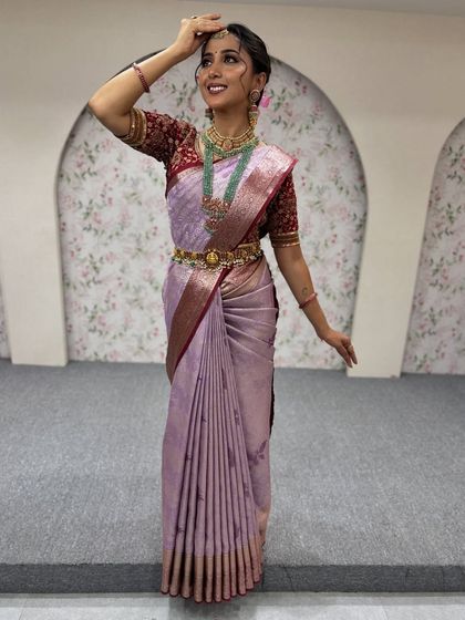 This candid pose shows the beautiful flow of the saree. My draping technique ensures the fabric moves with you, creating a graceful and dynamic look in photos.