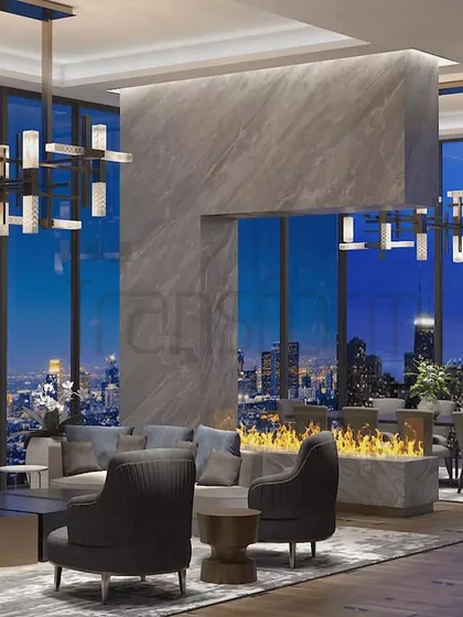 This Sky Villa living room was designed to merge timeless grandeur with panoramic city views. The central fireplace divides the seating and dining areas, creating zones for different activities while maintaining an open, airy feel.