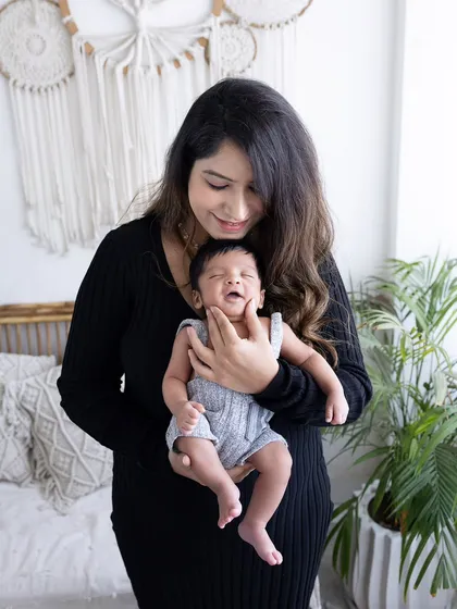 Capturing a fleeting expression, like this little yawn or smile from a newborn, is always a special treat. It adds a touch of personality to the portrait.