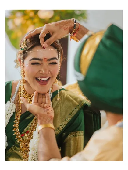 A moment of pure, unrestrained laughter during a wedding ritual. Capturing these genuine emotions is what makes a wedding album truly special.
