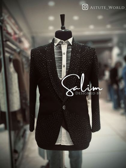 A mannequin showcasing a fully embellished tuxedo jacket. The entire surface is covered in black beads and sequins, creating a stunning, light-catching texture.