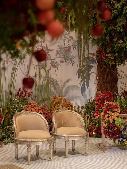 The sacred space for the naming ceremony, with two chairs and the baby's cradle set beneath the canopy of the indoor orchard.