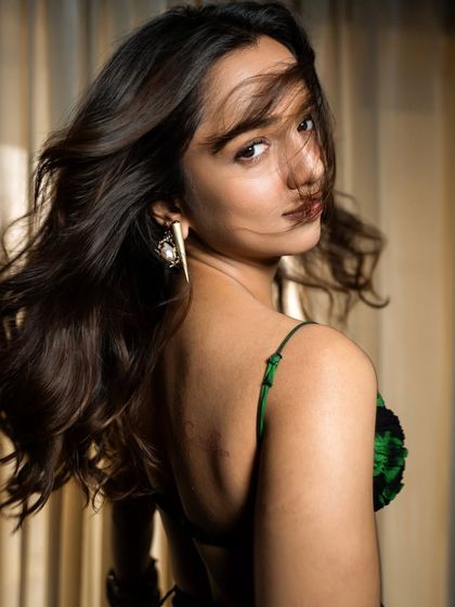 A dynamic shot showing movement in the hair and the interesting back detail of the top. Capturing energy and personality is key in a promotional photoshoot.