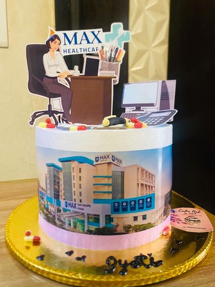 A corporate-themed cake for Max Healthcare, featuring the hospital building and office elements.