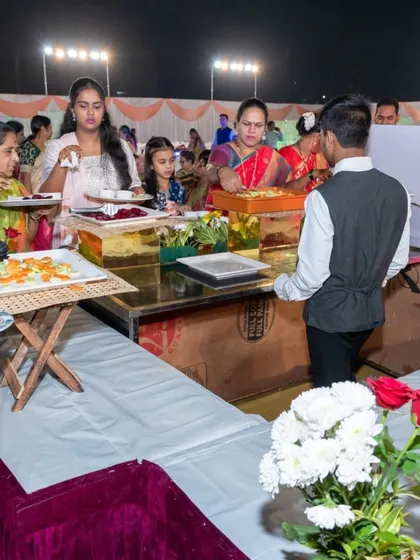 A guest being served at one of the decorated food stations. My staff ensures that every counter is well managed and always looks presentable.