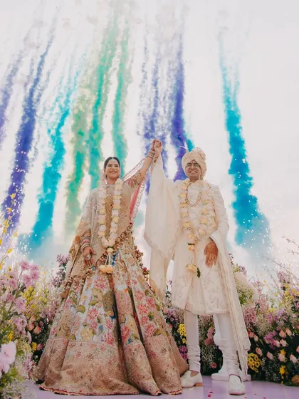 A moment of pure celebration for Vedika and Yuvraj at their Goa wedding. We love using dynamic elements like colored smoke to create vibrant, unforgettable images that capture the energy of the day. This is the kind of grand, joyful shot that feels like a scene from a movie.