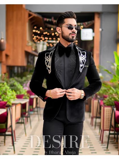 This image showcases the impeccable tailoring and luxurious feel of the black velvet tuxedo, a true statement of style and sophistication.