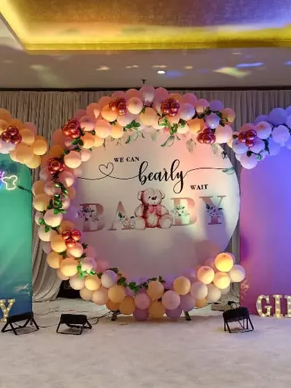 We loved creating this modern and adorable "We Can Bearly Wait" baby shower. The setup features three distinct backdrops with pastel balloon arches, marquee letters, and custom signage, creating a beautiful and expansive stage for the celebration.