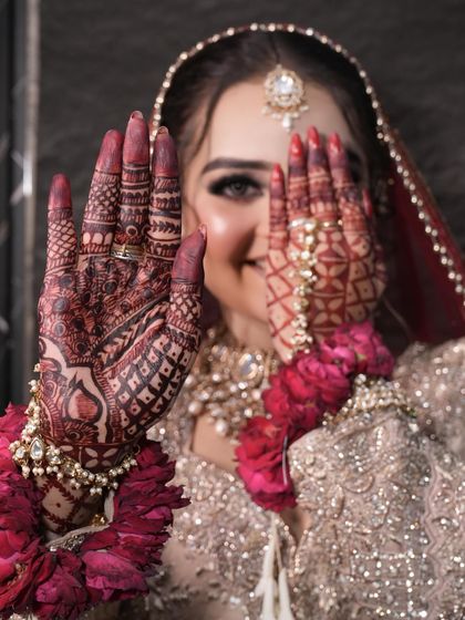 A playful shot showing off the intricate henna design, a beautiful part of the bridal preparations.