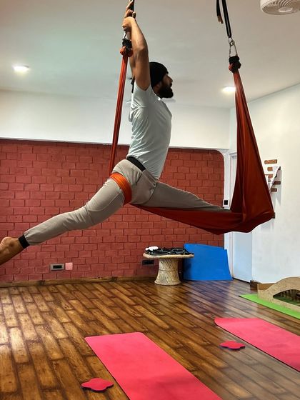 An impressive aerial split, demonstrating the incredible flexibility and strength that can be developed through this practice.