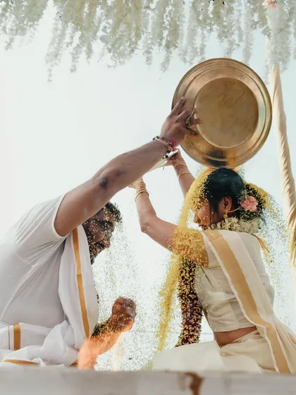 A playful and significant ritual in a South Indian wedding where the couple showers each other with rice, symbolizing prosperity and happiness.