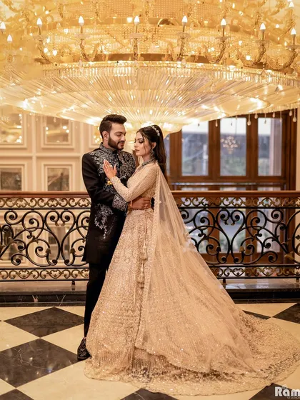 For couples who envision pure opulence, I find locations that match their dream. Here, the grandeur of the hall, with its magnificent chandelier and classic decor, provides a regal backdrop for this elegant pre-wedding portrait.