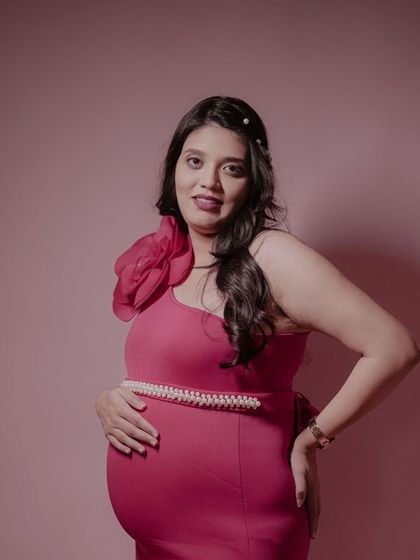 Our client looking stunning in a form-fitting magenta gown. The one-shoulder design with a large floral detail is a glamorous and modern choice.