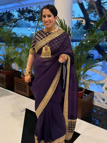 One of four stunning looks for the Oscar-winning producer Guneet Monga. This look in a deep purple saree is all about timeless elegance and grace.