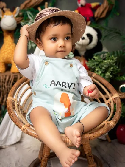 Ready for an adventure. This jungle-themed first birthday setup, complete with a personalized outfit, is a fun and creative way to celebrate the big one.