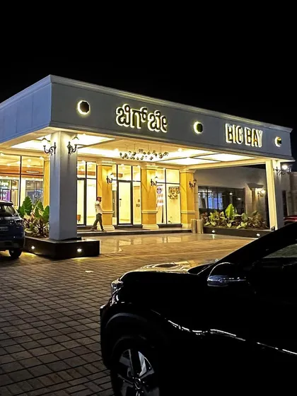 A beautiful shot of our main entrance at night, with a car parked out front, capturing the premium and inviting feel of our establishment.
