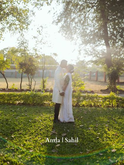 A romantic silhouette of the couple sharing a kiss against the setting sun. This beautiful shot from their South Indian wedding is the epitome of a fairytale moment.