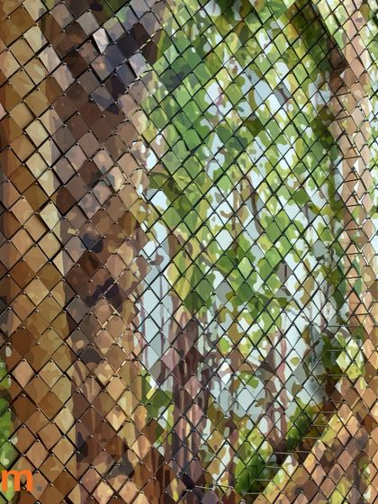 A close-up of the tree-inspired sculpture at Taj Bangalore. The mosaic of metallic tiles reflects the surrounding light and colors, creating an abstract impression of a tree canopy and celebrating Bengaluru's "Garden City" heritage through craft.