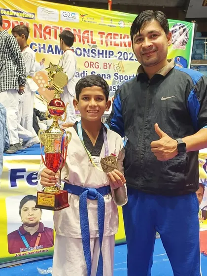 This student is thrilled with his trophy and bronze medal. A great achievement.