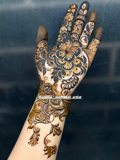 A bold and beautiful single-hand design featuring a large, intricate flower on the back of the hand.