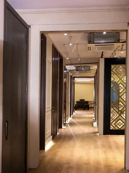 A look down the hallway of the showroom, lined with different designer door styles. It's like a gallery of possibilities for your home.