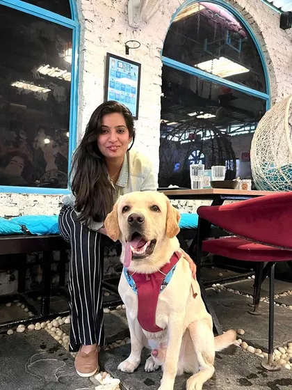 A proud owner with her well-behaved Labrador. Our cafe is a great place to show off your good boy or girl.